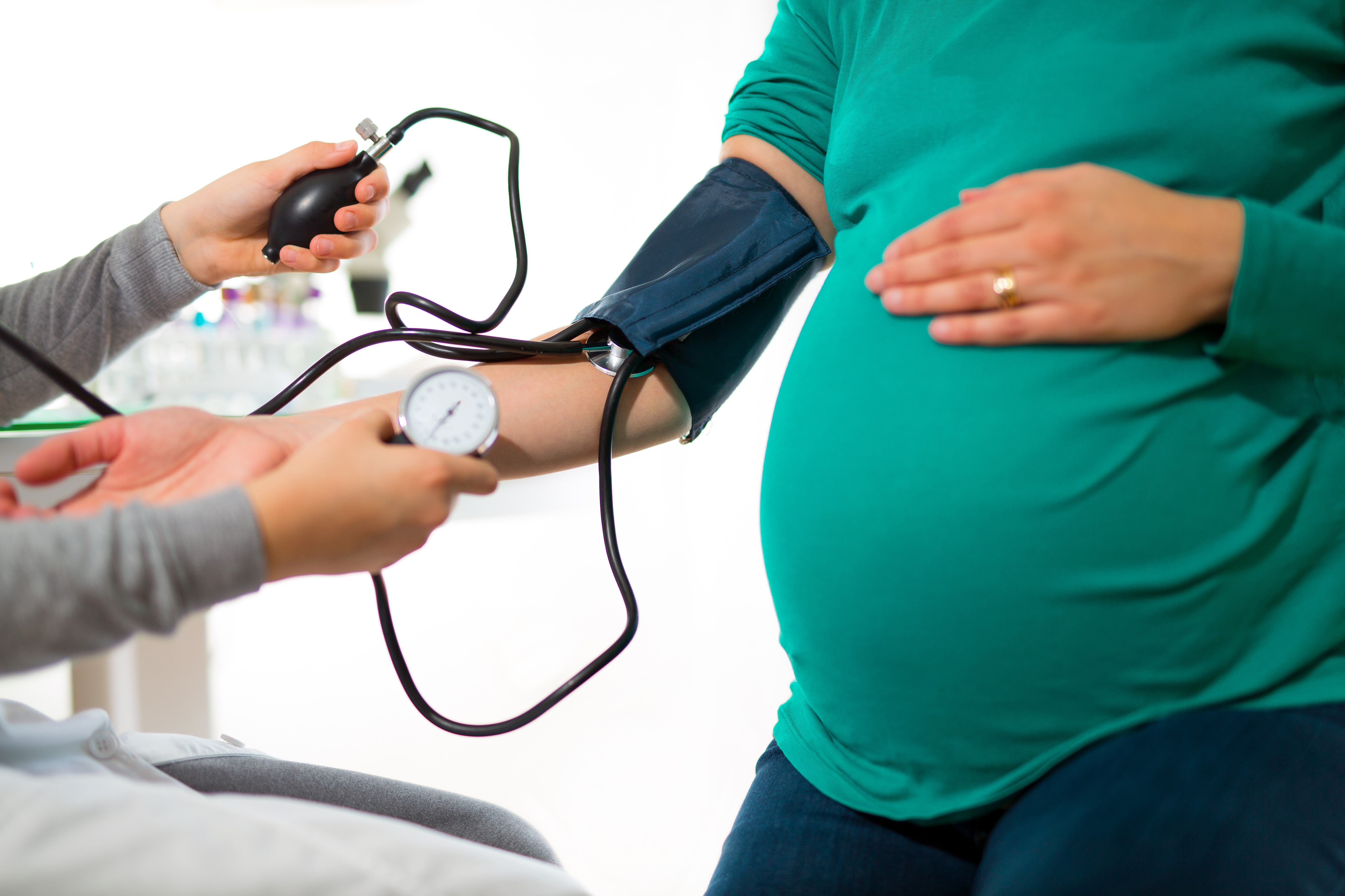Pregnant woman at doctor’s office having pressure measured